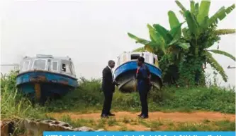  ??  ?? LAGOS: People discuss near abandoned speed boats at Bayeku jetty, Ikorodu district of Lagos, Nigeria’s commercial capital. —AFP