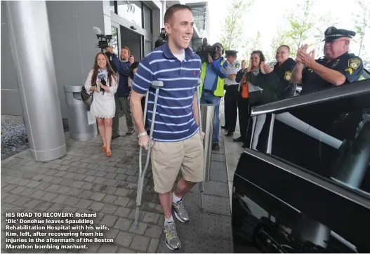  ?? STAFF FILE PHOTO BY PATRICK WHITTEMORE ?? HIS ROAD TO RECOVERY: Richard ‘Dic’ Donohue leaves Spaulding Rehabilita­tion Hospital with his wife, Kim, left, after recovering from his injuries in the aftermath of the Boston Marathon bombing manhunt.