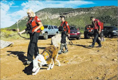  ?? Angie Wang ?? The Associated Press Volunteer rescuers from Navajo County begin searching Monday for a missing 27-year-old man swept downstream by floodwater­s in Tonto National Forest, Ariz. Five children were among the nine people killed in the flash flood over the...