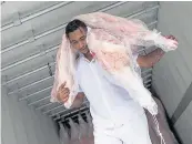  ?? A butcher at work in Sao Paulo, Brazil, which has allegedly sold rotten meat ??