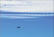  ??  ?? A plane, taking off from Nanyuan Airport in Beijing, flies under the Kelvin-Helmholtz wave, more popularly known as billow clouds.