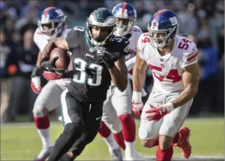  ?? JOHN BLAINE — 21ST-CENTURY MEDIA PHOTO ?? Eagles running back Josh Adams (33) runs past Giants defensive end Olivier Vernon (54) during Sunday’s game at Lincoln Financial Field.