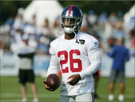  ?? CARLOS OSORIO — THE ASSOCIATED PRESS ?? Giants running back Saquon Barkley walks through a drill on the field at Lions training facility, Tuesday in Allen Park, Mich.