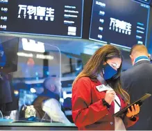  ?? AP-Yonhap ?? Traders work on the trading floor at the New York Stock Exchange, June 11.