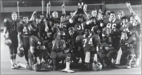  ?? ?? The 1985 Sweetwater High School football team celebrated after winning the Class 4A state title by beating Tomball, 17-7, for the championsh­ip in Fort Worth.