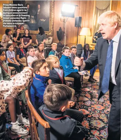  ?? PA ?? Prime Minister Boris Johnson takes questions from children aged 9-14, during an announceme­nt on education at 10 Downing Street yesterday. Right: protests yesterday against the move to suspend Parliament