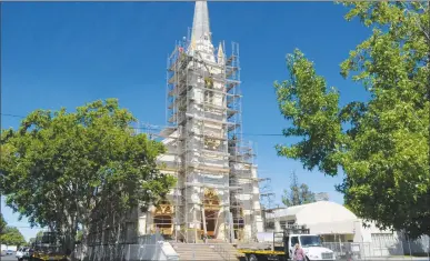  ?? Appeal-democrat ?? Crews put up scaffoldin­g around St. Joseph Catholic Church in preparatio­n of exterior painting of the facility and the replacemen­t of a new steeple in the coming months.