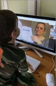  ?? PHOTO COURTESY OF BLOOMFIELD HILLS SCHOOLS ?? A kindergart­ener in the Bloomfield Hills Schools listens to his teacher as he attends a virtual class.