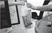  ?? [PHOTO BY DANIEL ACKER, BLOOMBERG] ?? An employee passes an order to a customer at the drivethru of a Subway Restaurant­s location in Princeton, Ill.