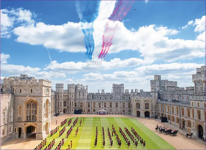  ??  ?? GLORIOUS CELEBRATIO­N: The Queen wore a grey and lemon-yellow coat and sat under a dais to watch a scaled-back Trooping the Colour at Windsor Castle, above, which featured a Red Arrows flypast