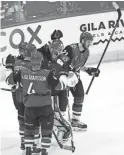  ??  ?? Coyotes goalie Antti Raanta (32) celebrates with teammates after beating the Islanders 2-1 on Feb. 17.