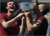  ??  ?? CUP OF CHEER: a delighted Murray (left) and Soares after winning the doubles at the US Open