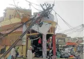  ?? Picture: REUTERS ?? WIND POWER: A building damaged by an electric pole in Alwar, in the western state of Rajasthan, India