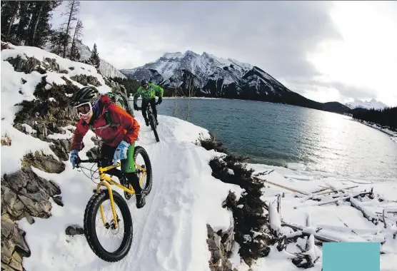  ?? PHOTOS: TRAVEL ALBERTA ?? Fat biking around Lake Minnewanka outside of Banff.