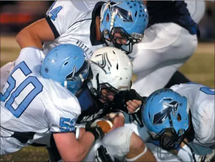  ?? MEDIANEWS GROUP FILE PHOTO ?? North Penn defenders stuff a Council Rock South ball carrier during their playoff contest on Friday November 26,2010.