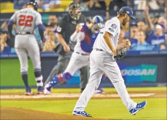  ?? Gina Ferazzi Los Angeles Times ?? CLAYTON KERSHAW reacts after an inning-ending strikeout in Game 2 of the series against Atlanta. Kershaw threw eight scoreless innings and allowed two hits.