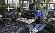  ?? NATI HARNIK — THE ASSOCIATED PRESS ?? Creighton pitchers Ben Dotzler, top center, and Tommy Steier, second right, watch President Trump declare a national emergency to combat the coronaviru­s pandemic, in the player lounge in Omaha, Neb.