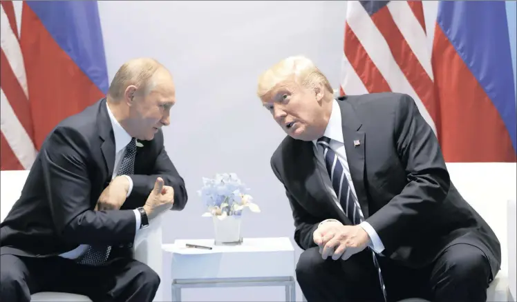  ?? Picture: EVAN VUCCI / AP ?? THAWING: President Donald Trump meets Russian President Vladimir Putin at the G20 Summit on Friday in Hamburg, Germany.