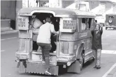  ?? ?? A commuter boards a public utility jeepney plying Taft Avenue in Manila. The Public Utility Vehicle modernizat­ion program of the government may cause jeepney drivers and operators to lose their livelihood.