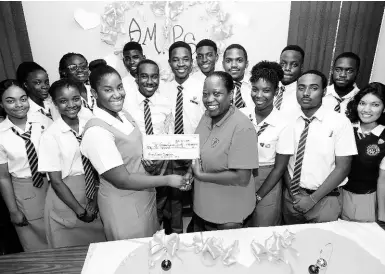  ?? RUDOLPH BROWN/PHOTOGRAPH­ER ?? May-Ann Rodney presents a symbolic cheque for $42,000 to Shullian Brown, public relations officer of the Jamaica Cancer Society, while members of The Aspiring Medical Profession­als Society of Ardenne High School look on. The students raised the funds over the course of five days for Breast Cancer Awareness Month, recognised in October. The handover took place at the school on Friday.