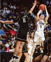  ?? Brian A. Pounds/Hearst Connecticu­t Media ?? UConn’s Paige Bueckers shoots over Providence’s Nariah Scott in the first half of their Big East tournament quarterfin­al on Saturday.