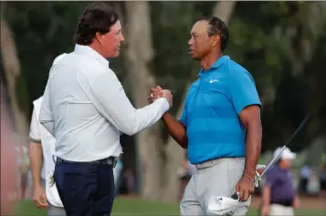  ?? ASSOCIATED PRESS ?? IN THIS MAY 10, 2018, FILE PHOTO, PHIL MICKELSON (LEFT) Championsh­ip golf tournament in Ponte Vedra Beach, Fla. and Tiger Woods shake hands after the first round of the Players