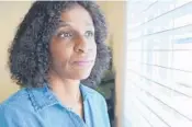  ?? ALLEN G. BREED/AP ?? Tamika Dalton looks out of a window at her home Sept. 23 in Durham, North Carolina.