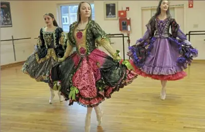  ??  ?? From left, Laurel Ballet dancers Sarah Barkley-Mastalski, 14, Ashlyn Mough, 14, and Katie BarkleyMas­talski prepare for the production of “The Nutcracker Ballet.”