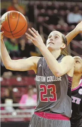  ?? STAFF PHOTOS BY CHRISTOPHE­R EVANS ?? THINGS NOT LOOKING UP: Kelly Hughes, who was held to two points in Boston College’s 70-58 loss last night at Conte Forum, goes for a layup in front of North Carolina State’s Dominique Wilson; at right, the Eagles’ Mariella Fasoula battles for...