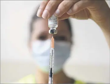  ?? Alain Jocard Asociated Press ?? A HEALTH worker prepares a monkeypox vaccinatio­n. The FDA has approved a two-dose Jynneos series.