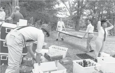  ?? ILANA PANICH-LINSMAN/THE NEW YORK TIMES ?? Workers set up for a wedding Aug. 7 at The Inn at Kenmore Hall in Richmond, Mass. Weddings are roaring back after a pandemic-induced slump, leading to booked-up venues, a dearth of photograph­ers and rising prices on dinners.