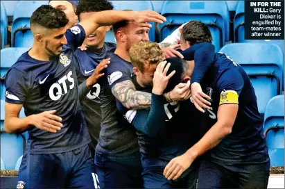 ??  ?? IN FOR THE KILL: Gary Dicker is engulfed by team-mates after winner
