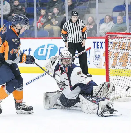  ?? TODD BOONE/FLINT FIREBIRDS ?? Spitfires goaltender Kari Piiroinen makes a save on a shot by the Firebirds’ Eric Uba during their game Friday night at the Dort Federal Event Center in Flint, Mich. The Firebirds went on to defeat the Spitfires 3-1.