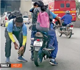  ?? — Gandhi ?? A motorist helps a kitten that was found on the main road near National Institute of Nutrition campus. He stopped his vehicle and forced other vehicles to stop so that he could pick up the kitten and release it in the campus of the NIN.