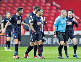  ??  ?? Flashpoint: Jonathan Moss is surrounded by Bournemout­h players during their defeat at Sheffield United on Sunday