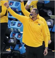  ?? DARRON CUMMINGS — THE ASSOCIATED PRESS ?? Michigan head coach Juwan Howard celebrates at the end of a second-round game against LSU in the NCAA tournament at Lucas Oil Stadium on Monday in Indianapol­is. Michigan won 86-78.