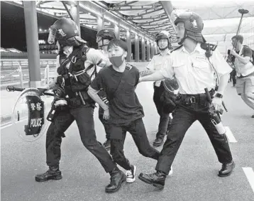  ?? VINCENT YU/AP ?? Police arrest a protester during a clash Tuesday at the airport in Hong Kong where demonstrat­ors shut down operations.