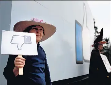  ?? Justin Sullivan Getty Images ?? PROTESTERS with a group called Raging Grannies demonstrat­e outside Facebook headquarte­rs Thursday in Menlo Park, Calif. Critics have rebuked the social media company for failing to safeguard its users’ data.