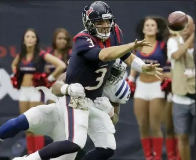  ?? DAVID J. PHILLIP — THE ASSOCIATED PRESS ?? Texans quarterbac­k Tom Savage (3) tosses the ball as he (57) during the second half Sunday in Houston. is hit by Indianapol­is linebacker Jon Bostic