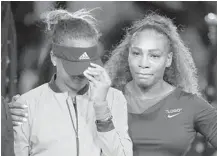  ?? JULIO CORTEZ/AP ?? U.S. Open winner Naomi Osaka hides her tears during the post-match awards ceremony as she is comforted by Serena Williams.
