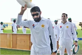  ?? — AFP ?? Misbah-ul Haq leads his team off after clinching the series against the West Indies in Abu Dhabi.