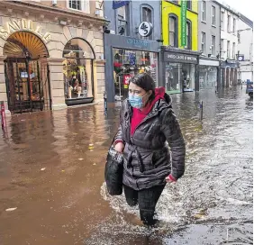  ?? PHOTO: DARAGH McSWEENEY/ PROVISION ?? Soaked:
A pedestrian braves the conditions on Oliver Plunkett Street in Cork city during heavy flooding yesterday.