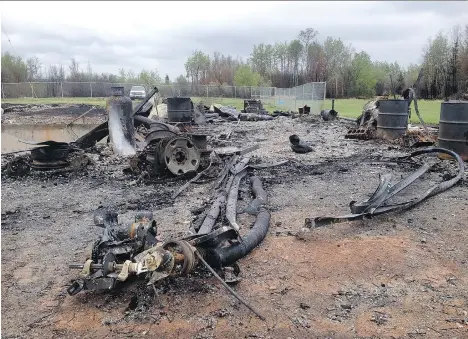  ??  ?? The remains of a building destroyed by wildfire are seen on the ground along the Alaska Highway. The fire is about 45 kilometres north of Fort St. John.