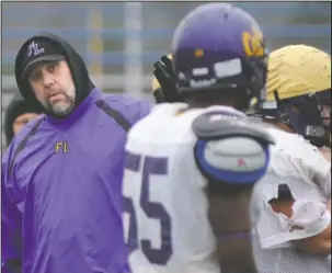  ?? The Sentinel-Record/Mara Kuhn ?? PURPLE AND GOLD: Before becoming the school’s athletic director, Marc Davis, left, serves as head football coach at Fountain Lake and later as an assistant to current Lake Hamilton coach Tommy Gilleran. New Fountain Lake coach J.D. Plumlee, Gilleran...