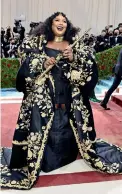  ?? ?? Alicia Keys’ Ralph Lauren dress was inspired by her native New York City, with a cape evoking the New York City skyline outlined in small hand-placed crystals. Keys said her dress was meant to “represent an empire state of mind and a city of gods here tonight.”