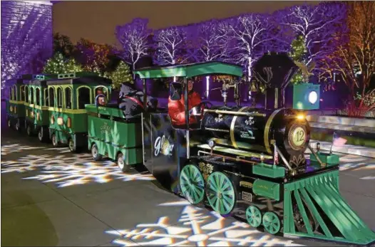  ?? PHOTOS COURTESY OF CLEVELAND BOTANICAL GARDEN ?? Children can climb aboard the Garden Express train for a ride through the gardens during “Glow” at the Cleveland Botanical Garden.