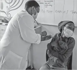  ?? JOAO SILVA NEW YORK TIMES FILE PHOTO ?? A participan­t in a COVID-19 vaccine trial receives an injection at a research center in Johannesbu­rg on Dec. 8. Moderna says its vaccine is effective against some new variants of the coronaviru­s that have emerged in Britain and South Africa.