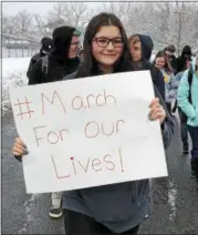  ?? NICHOLAS BUONANNO — NBUONANNO@TROYRECORD.COM ?? Cohoes High School 10th grader Brianna Ferrand holds up a sign as she walks around the high school with other students.