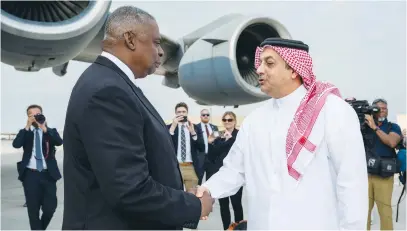  ?? (US Air Force/Reuters) ?? US DEFENSE Secretary Lloyd Austin is greeted by Qatar’s Defense Minister Khalid bin Mohammad Al Attiyah, during a visit to al-Udeid Air Base, in Doha, Qatar, in December.