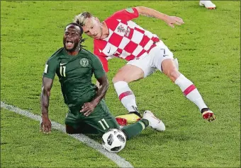  ?? MICHAEL SOHN/AP PHOTO ?? Nigeria’s Victor Moses (11) is fouled by Croatia’s Ivan Rakitic during Saturday’s World Cup Group D match in Kaliningra­d, Russia. Croatia won 2-0.